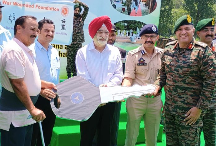 GOC, Rajouri Division, Maj Gen Gaurav Rishi handing over keys of modified scooters to disabled soldiers in Rajouri on Tuesday.