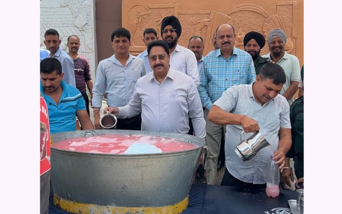 Cooling compassion: Amar Singh Club staff, guided by Honorary Secretary Anil Kapahi, serving sweet drinks to soothe the public in the scorching heat in Jammu on Saturday.