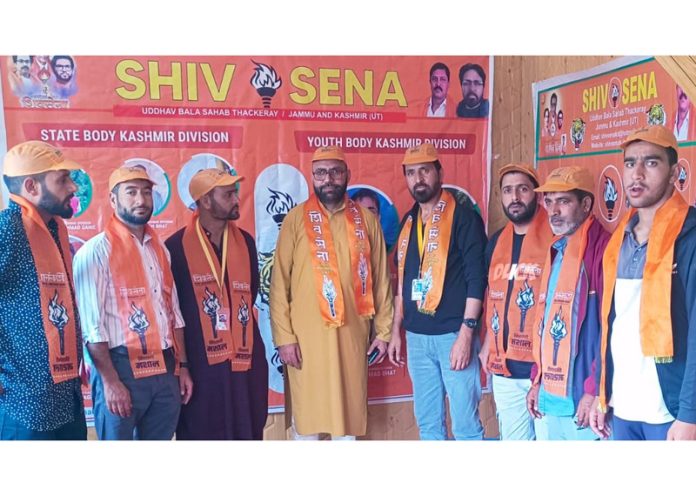 New entrants of Shiv Sena (UBT) posing with Kashmir in-charge Malik Bashir at a joining function in Kupwara.