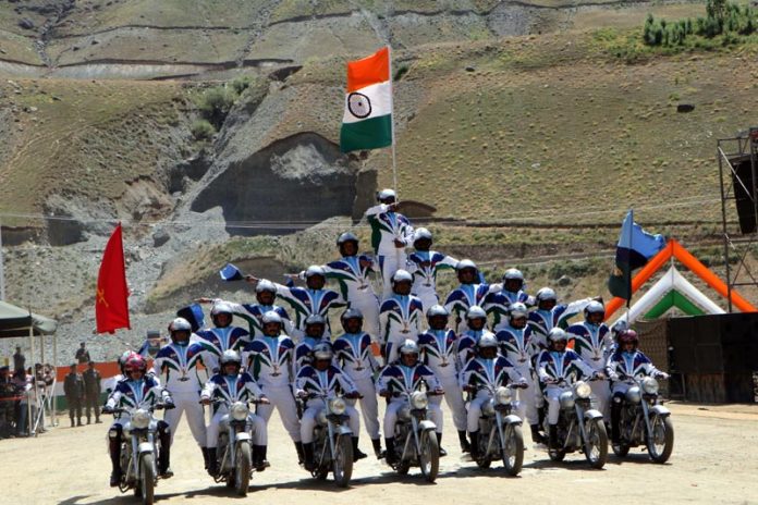 Troops performing motorbike stunts to honour the valour and sacrifices of the Kargil war heroes on the eve of 25th anniversary of Kargil war on Thursday. (UNI)
