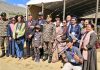 Army chief Gen Upendra Dwivedi posing with students, war veterans and others at Drass in Kargil on Thursday.
