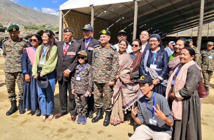 Army chief Gen Upendra Dwivedi posing with students, war veterans and others at Drass in Kargil on Thursday.
