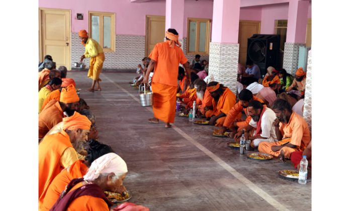 Shri Amarnath Ji bound Sadhus being served Prashad at Ram Mandir Jammu on Thursday. -Excelsior/Rakesh