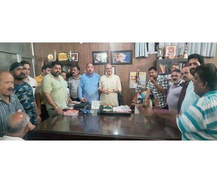 Senior BJP leader Kavinder Gupta with members of Nai Basti shopkeepers’ delegation at his office in Jammu.