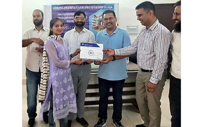 Director JKEDI giving certificate to a Tejaswini Scheme beneficiary at Ramban.