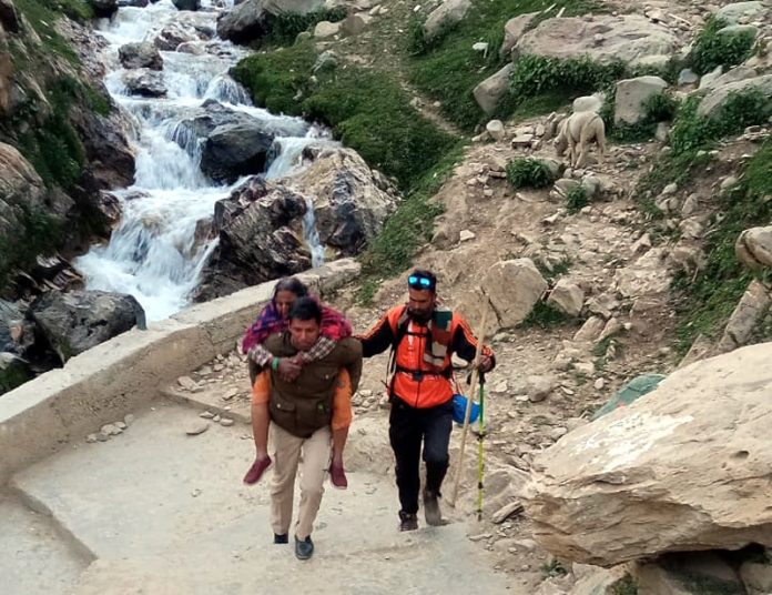 Police cop carrying Yatri on his shoulder who was unable to walk during ongoing Amarnath Yatra. 