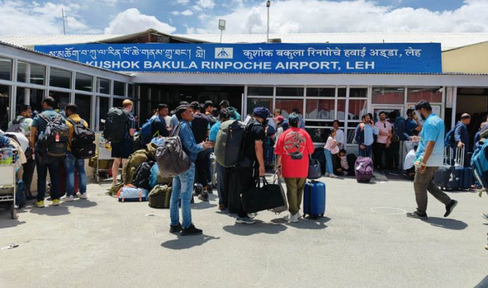 Passengers stranded at Leh airport after cancellation of flights due to rise in temperature on Monday.