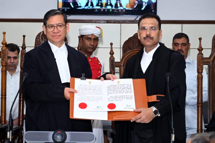 Chief Justice N Kotiswar Singh administering oath to Justice Rajesh Sekhri.