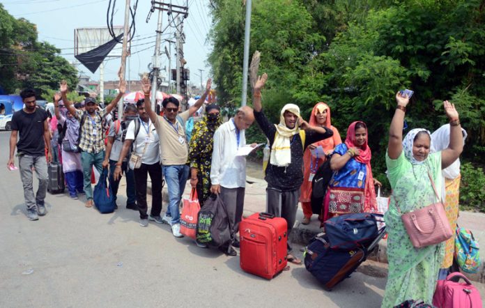 Shri Amarnath Ji bound pilgrims waiting in a queue to enter Bhagwati Nagar Yatri Niwas on Wednesday. —Excelsior/Rakesh