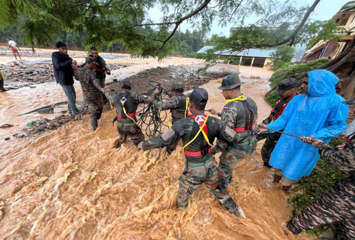Army personnel on a rescue operation in the landslide hit Wayanad district of Kerala on Tuesday. (UNI)