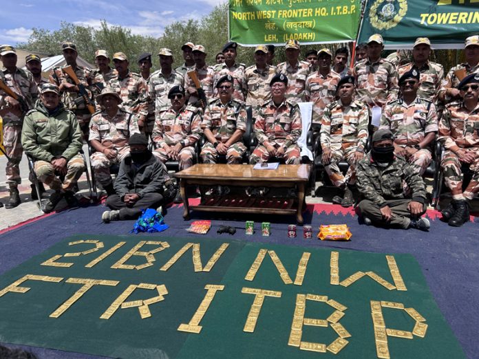 ITBP jawans with seized gold and other items in Leh on Wednesday.