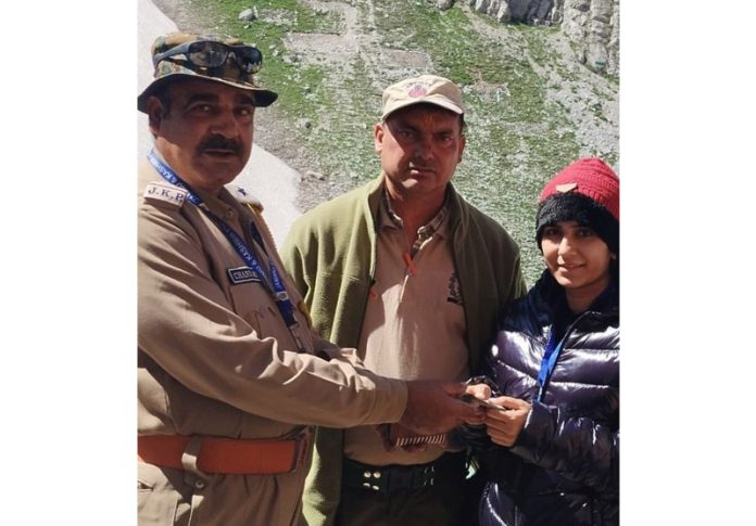 Cops of Jammu and Kashmir Police returning Rs 10,000 to a pilgrim who had left the money near holy cave on Friday.