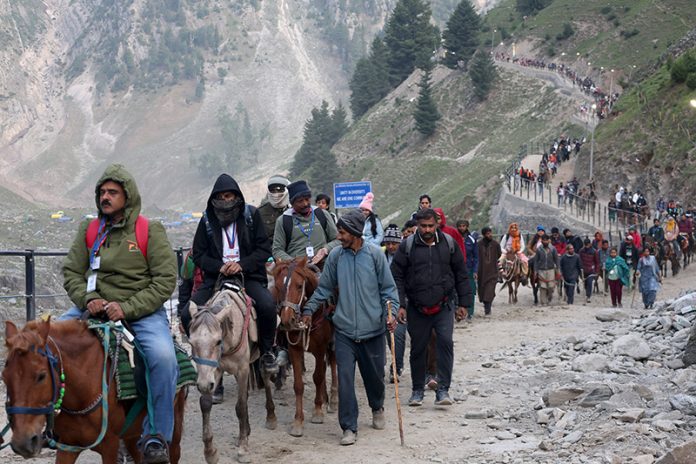 Pilgrims leaving for holy cave from Baltal base camp on Sunday. —Excelsior/Shakeel