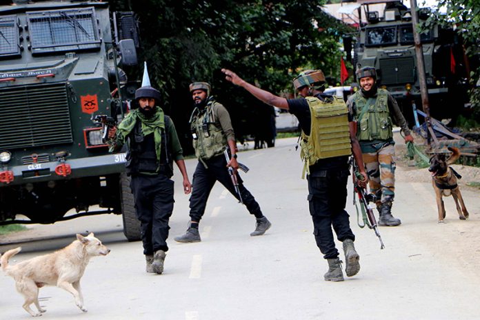 Security forces walk towards the encounter site at Chinigam, Kulgam on Sunday.