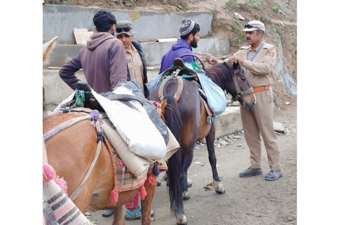 JKP cops checking the yatris and service providers near holy cave on Saturday.