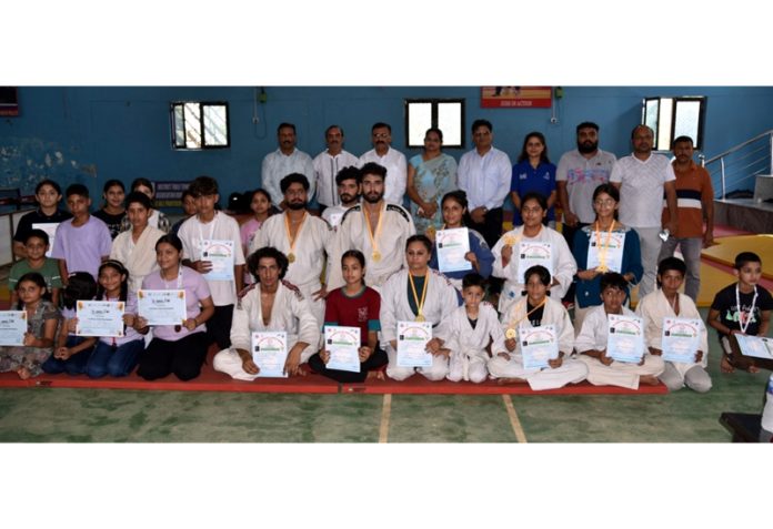 Judo athletes posing along with certificates and medals at Udhampur on Tuesday.