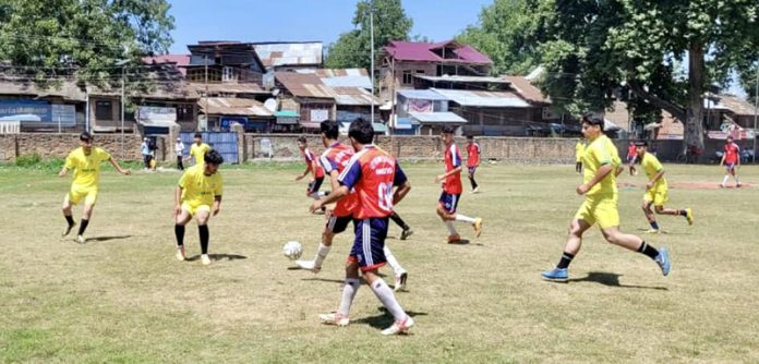 Football players in action during a match in Anantnag.