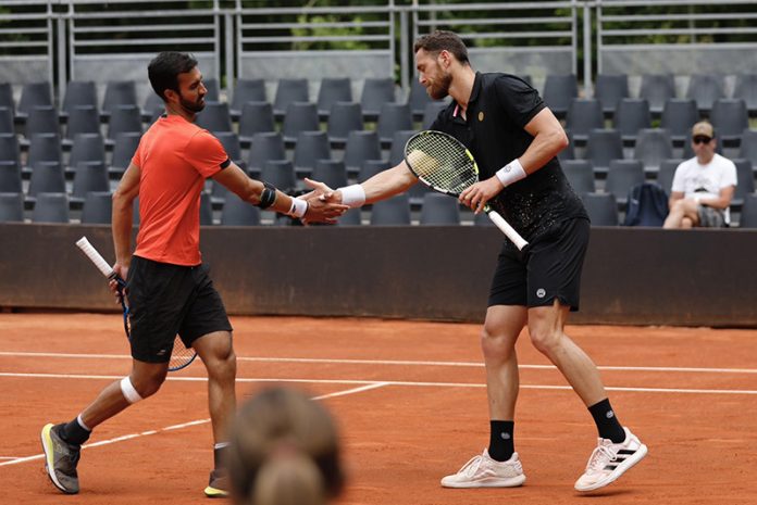 Yuki Bhambri and his French partner Albano Olivett shaking hands after winning Swiss Open ATP Tour doubles final.