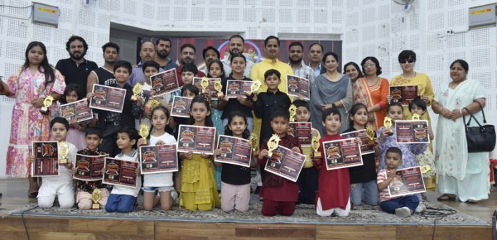 Toddlers posing with certificates during talent show at Jammu