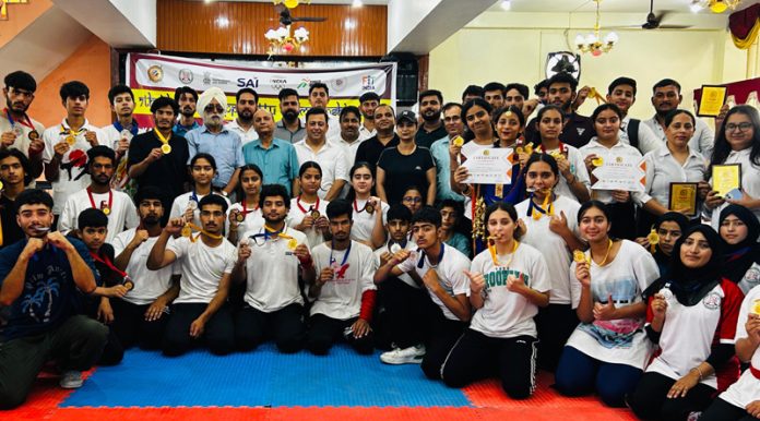 Athletes of Kalaripayattu displaying medals while posing for photograph during the closing ceremony in Jammu on Sunday.