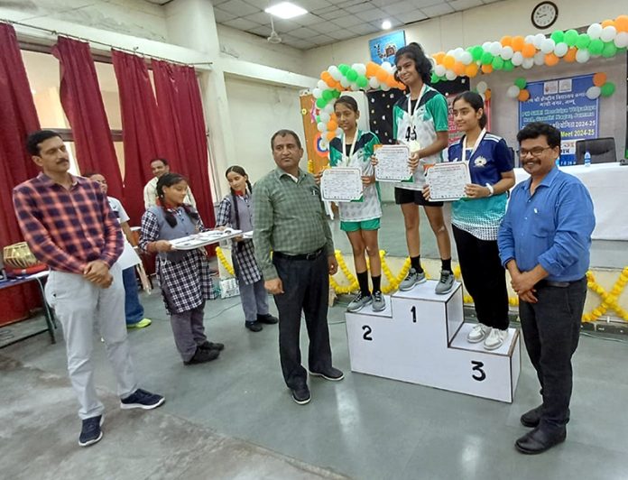 Players posing along with certificates on podium during KVS Regional Sports Meet 2024-25.