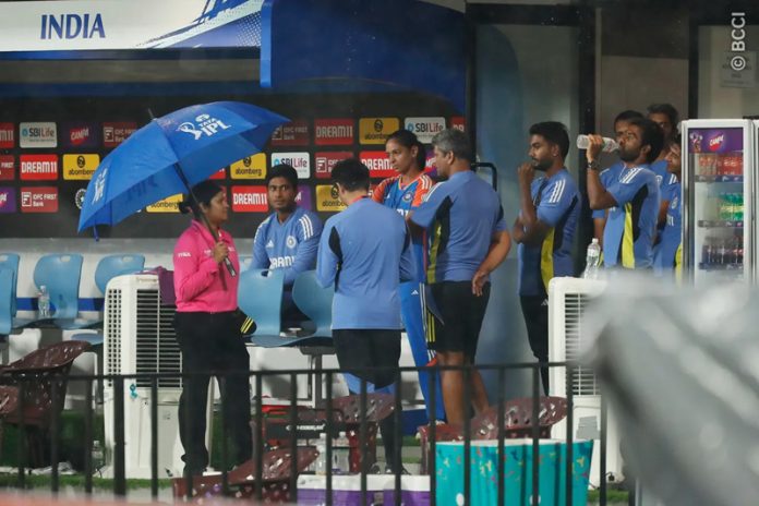 Indian Women’s team captain Harmanpreet Kour along with umpire and team staff waiting for rain to stop at Chennai on Sunday.
