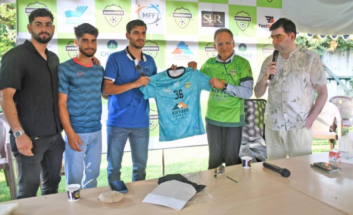 Srinagar Downtown Heroes FC chairman Irfan Shahmiri presenting jersey to footballers.