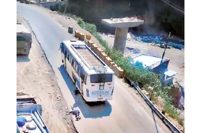 A passenger falls on road after jumping from out of control bus in Nachlana area of Ramsu on Tuesday.