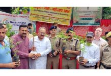 Dignitaries distributing plants on the start of Sanskrit Month in Jammu on Tuesday.