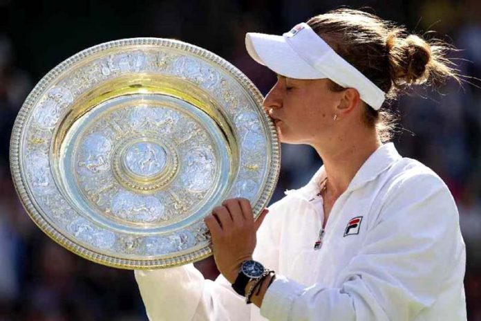 Barbora Krejcikova kissing a trophy after winning Grand Slam title.