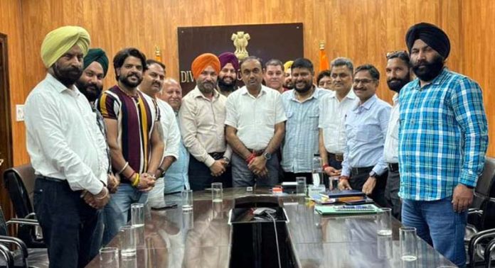Transporters posing for a photograph with Divisional Commissioner Jammu on Friday.