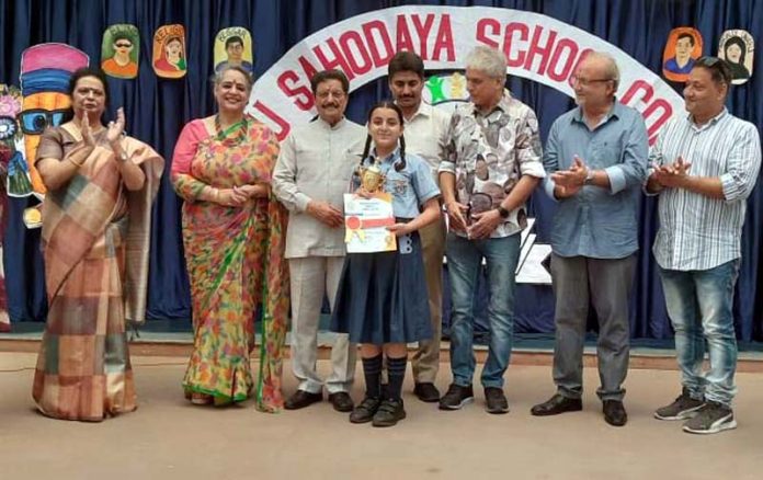 Renowned J&K artists and Management of Rich Harvest School presenting certificate to a student during a programme on Wednesday.