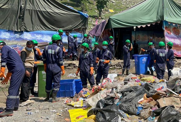 Sanitation workers processing the dry waste collected from the route of Shri Amarnath Yatra.