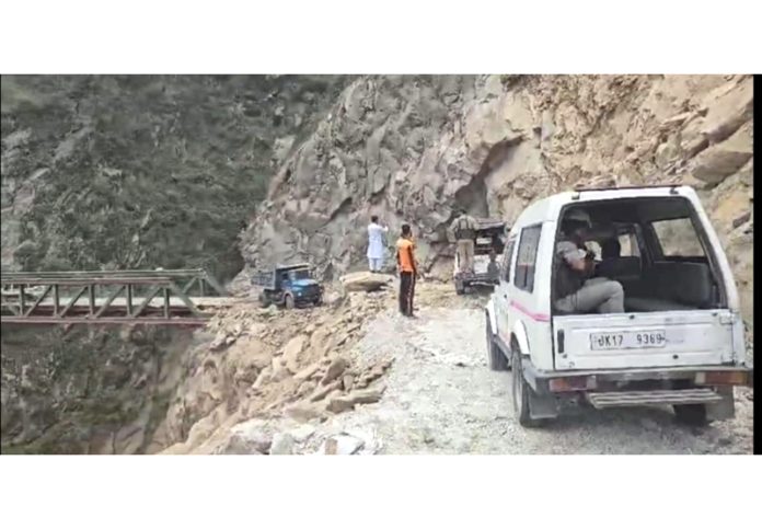 Vehicles passing through Kishtwar-Paddar road after it was reopened on Wednesday.