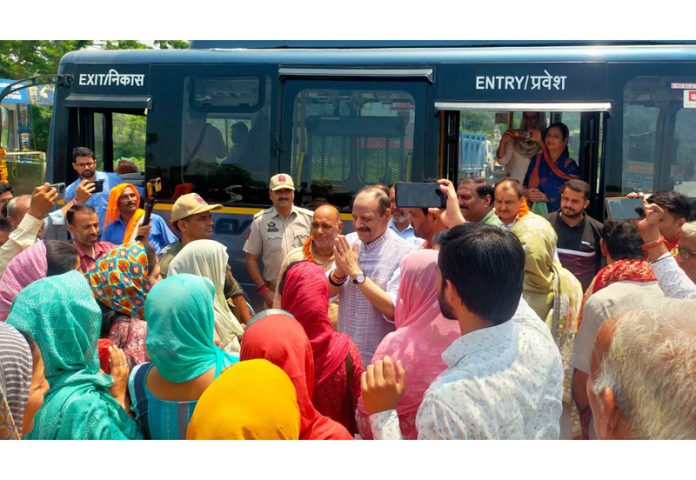 Senior BJP leader Devender Singh Rana interacting with people before flagging off e-bus.