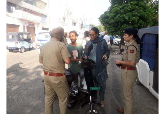 RTO team and Traffic Police challaning the violators in Jammu City on Friday.