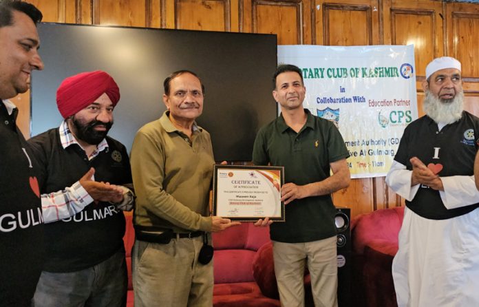 Advisor to LG Rajeev Rai Bhatnagar presenting certificate to Rotary Club members on Saturday.