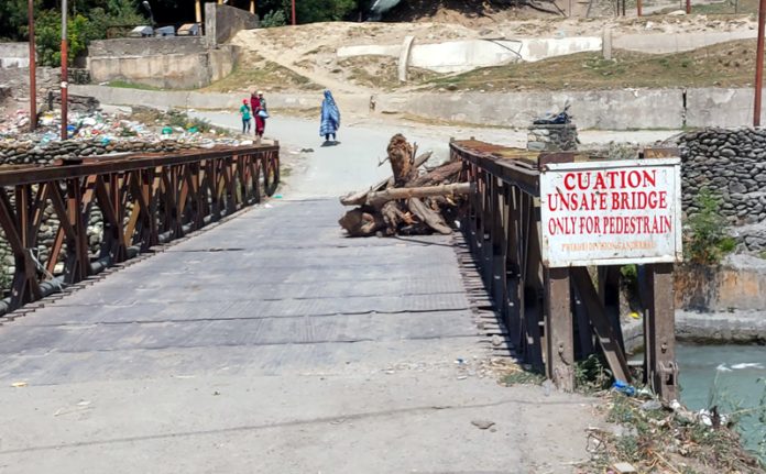 Unsafe bridge in Sumbal Bala of district Ganderbal posing risk to commuters. -Excelsior/Firdous