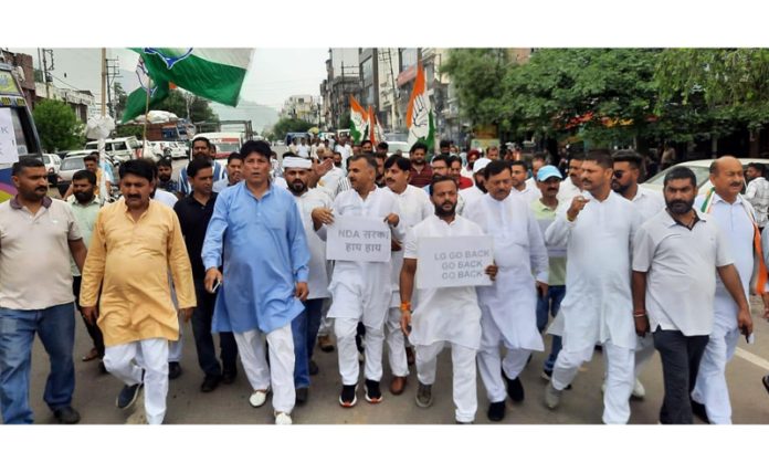 DDC leaders and workers staging protest march against BJP at Udhampur on Thursday.