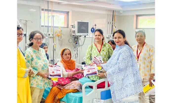 JMI members presenting health and hygiene kit to a patient in Gynaecology ward of Government Hospital, Gandhi Nagar (Jammu).