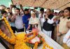 Senior BJP leader Devender Singh Rana paying tribute to martyr.