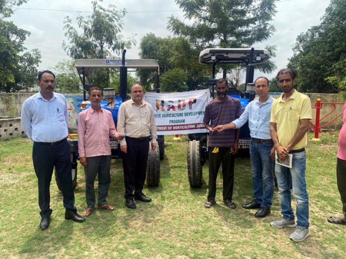 Director Horticulture Jammu, C L Sharma handing over keys of two tractors under HADP Scheme to farmers in Khour area of Jammu.