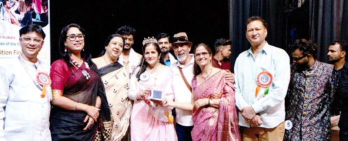 Chayya Raina, a deaf woman from Jammu posing with her award, she won at 6th Murshidabad National Deaf Film Festival on Friday.