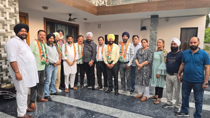 Cong Coordination Committee members with new entrants during a function in Jammu South.