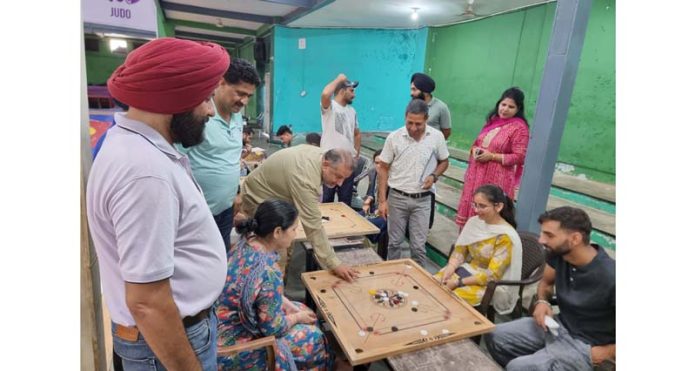 Chairman of the Campus Sports Committee Dr Daud Iqbal Baba playing a Carrom in Jammu University on Tuesday.