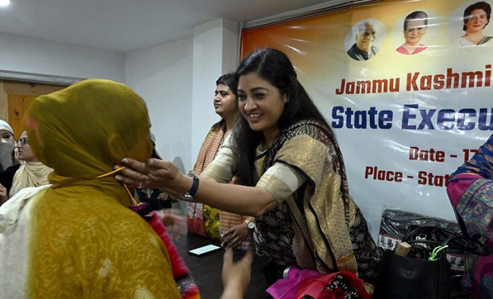 Alka Lamba, National President of the All India Mahila Congress distributing sweets to workers at Srinagar Congress Office on Saturday. -Excelsior/Shakeel