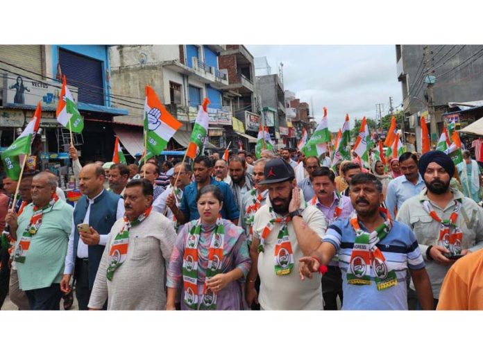 Cong leader Mohinder Bhardwaj leading a rally in Vijaypur on Monday.