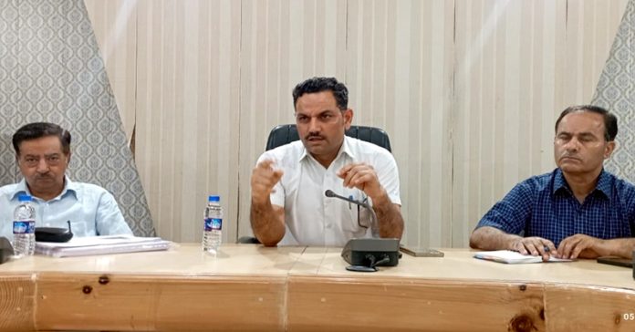 DC Rajouri Om Prakash Bhagat chairing a meeting on Monday.