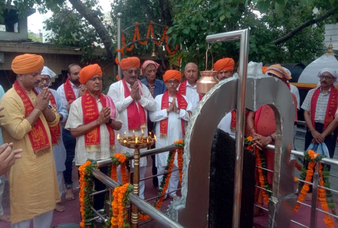 Priests performing Pooja of Lord Shani Dev at Shri Lakshmi Narayan Temple, Gandhi Nagar in Jammu.