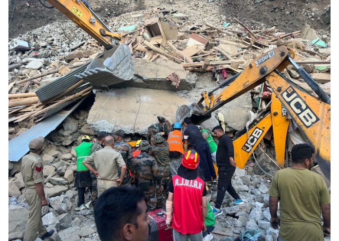 The rescue teams evacuating injured persons from the debris of a house that collapsed in Kabaddi Nallah area of Kargil district on Saturday. -Excelsior/Basharat Ladakhi